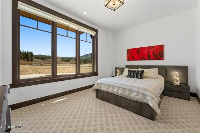 a bedroom with a large bed and a large window