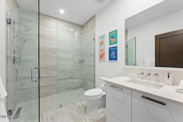 a bathroom with a sink shower and a toilet