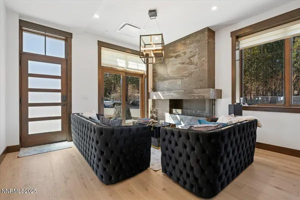 a living room with fireplace furniture and a window