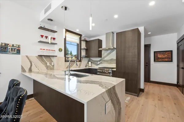 a kitchen with stainless steel appliances a sink and a refrigerator