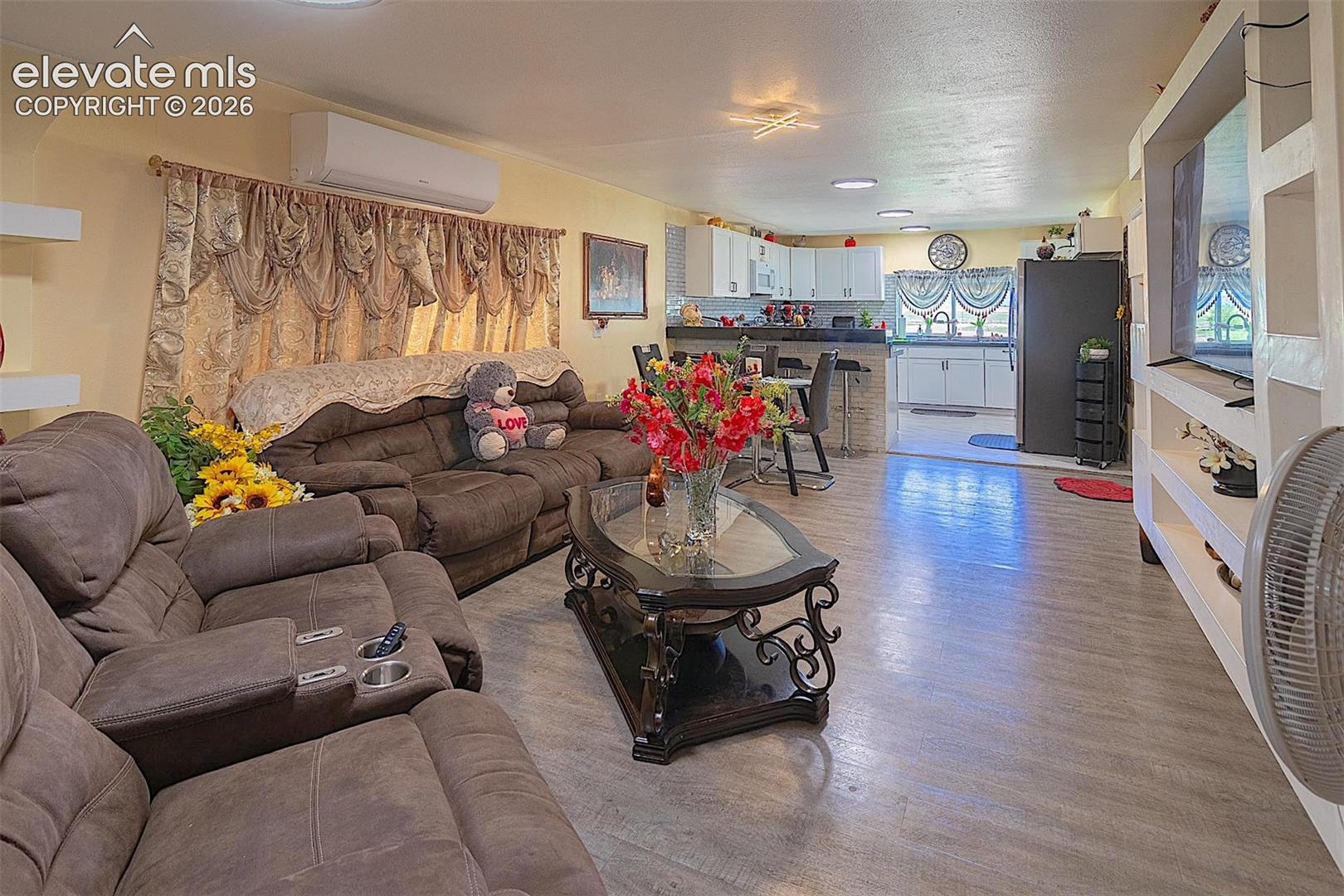 3425 Wiesner Road Calhan, CO 80808 - Photo 23 of 25 Living room with an AC wall unit and light wood-type flooring
