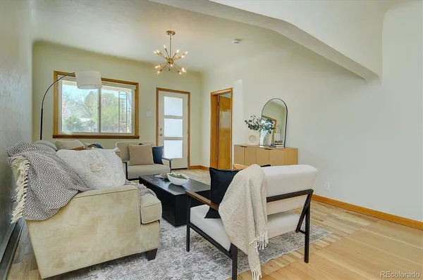 a living room with furniture and a chandelier