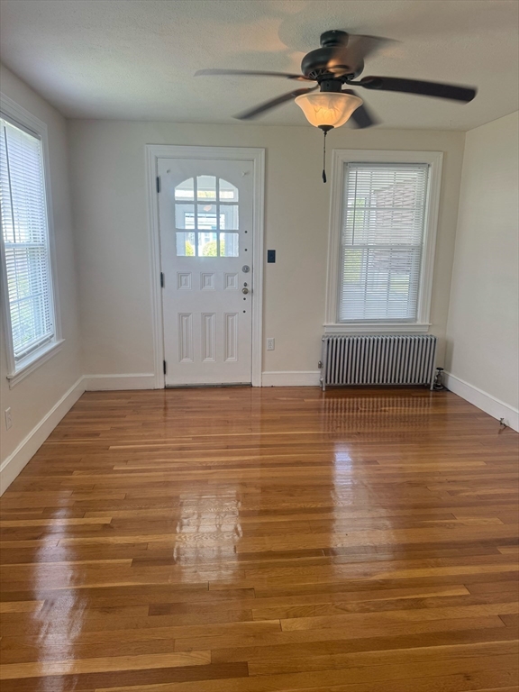 90 Elijah Street Springfield, MA 01109 - Photo 14 of 42 wooden floor in an empty room with a window