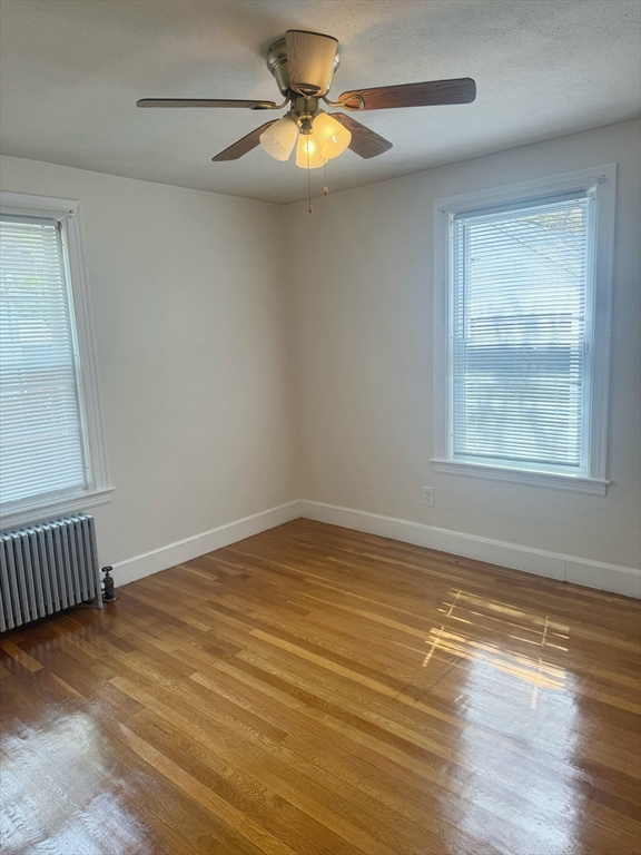 90 Elijah Street Springfield, MA 01109 - Photo 15 of 42 a view of an empty room with window and wooden floor