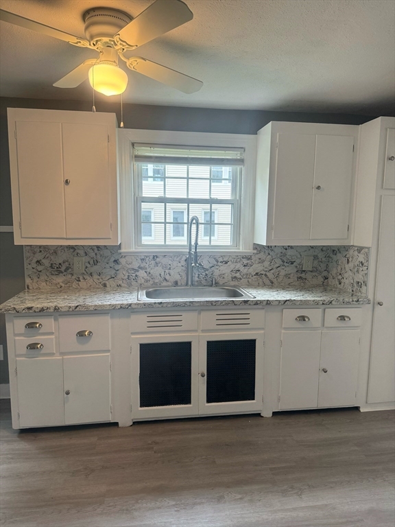 90 Elijah Street Springfield, MA 01109 - Photo 23 of 42 a sink with white cabinets