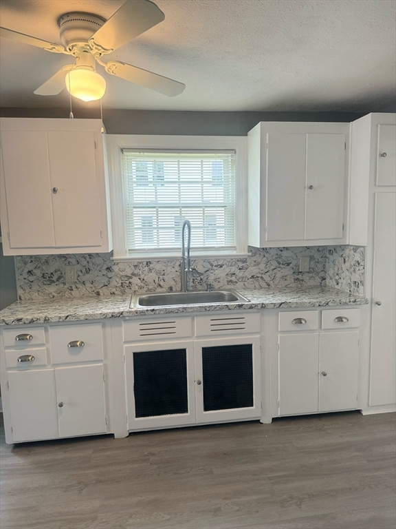 90 Elijah Street Springfield, MA 01109 - Photo 26 of 42 a kitchen with granite countertop white cabinets and a granite counter tops