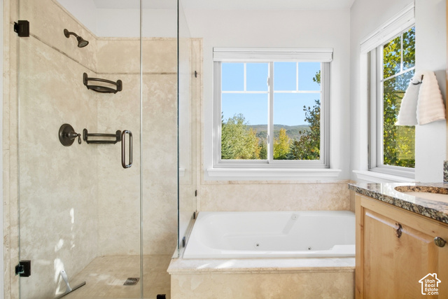 7396 Brook Hollow Loop Road Park City, UT 84098 - Photo 22 of 60 Glass-enclosed shower with bronze fixtures and stone-finish tiling