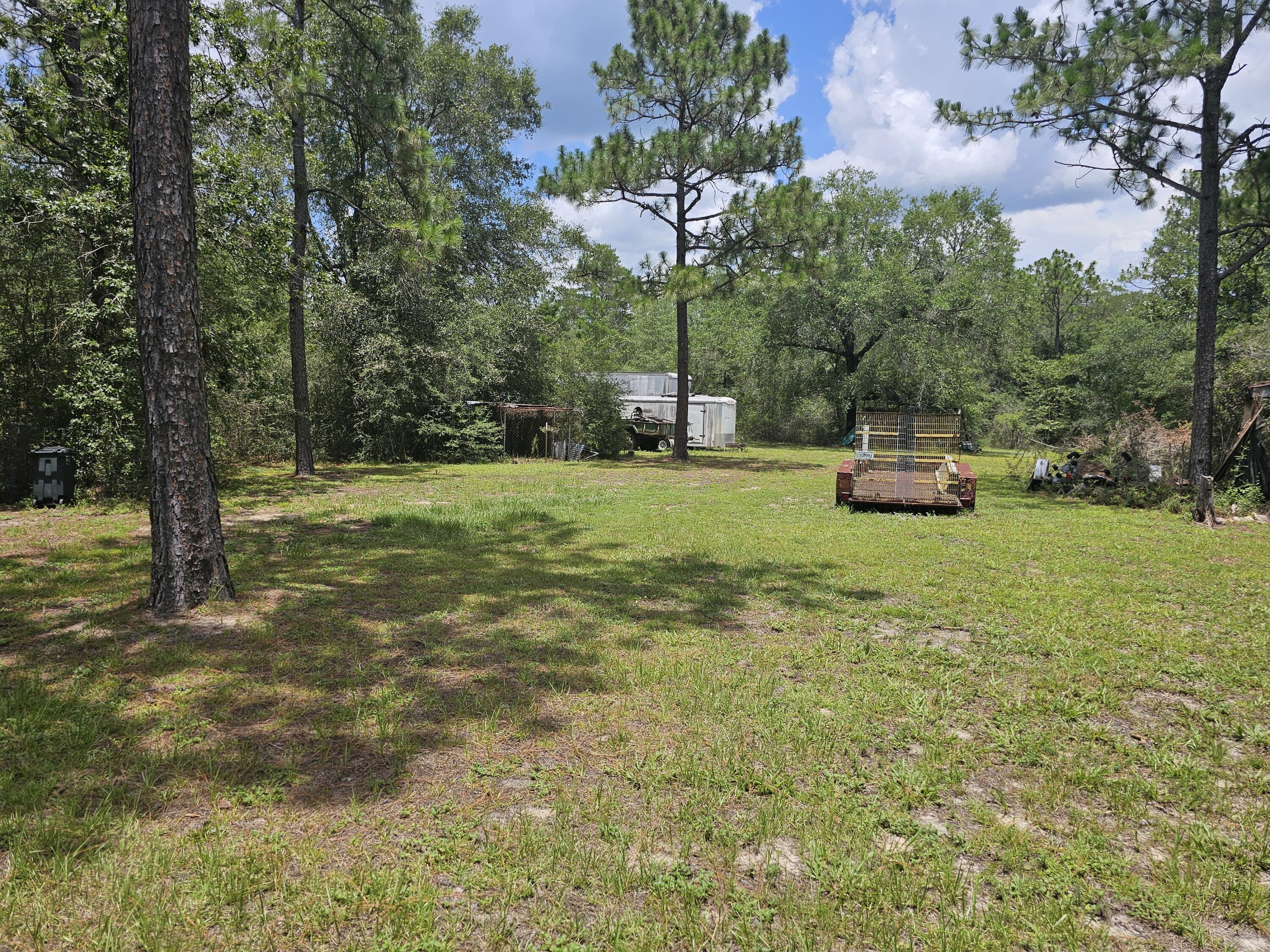 400 7 Oaks Road DeFuniak Springs, FL 32433 - Photo 16 of 17 a view of a trees in a yard