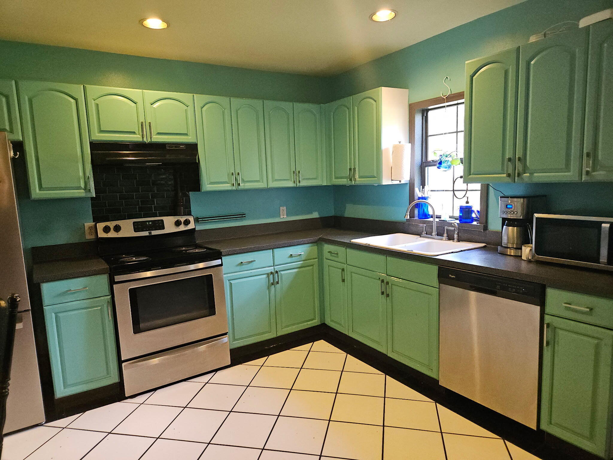 400 7 Oaks Road DeFuniak Springs, FL 32433 - Photo 3 of 17 a kitchen with granite countertop a stove top oven sink and cabinets