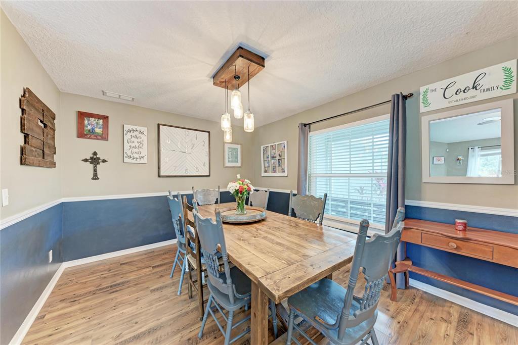 4608 Oliver Manor Drive Parrish, FL 34219 - Photo 12 of 45 a view of a dining room with furniture window and wooden floor