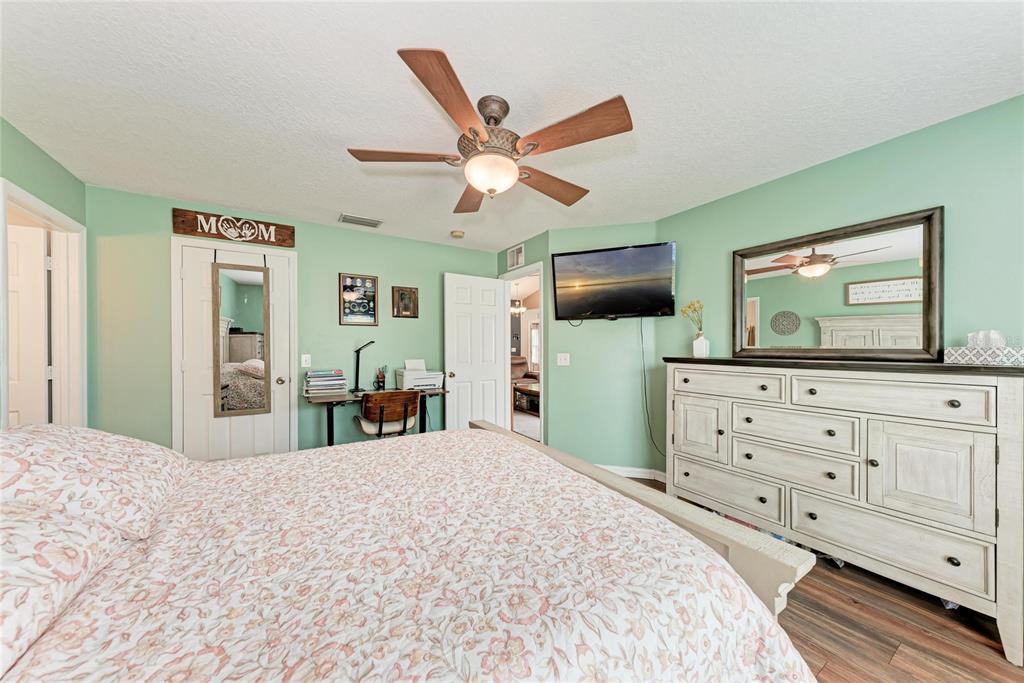 4608 Oliver Manor Drive Parrish, FL 34219 - Photo 15 of 45 a bedroom with a bed a large mirror and dresser