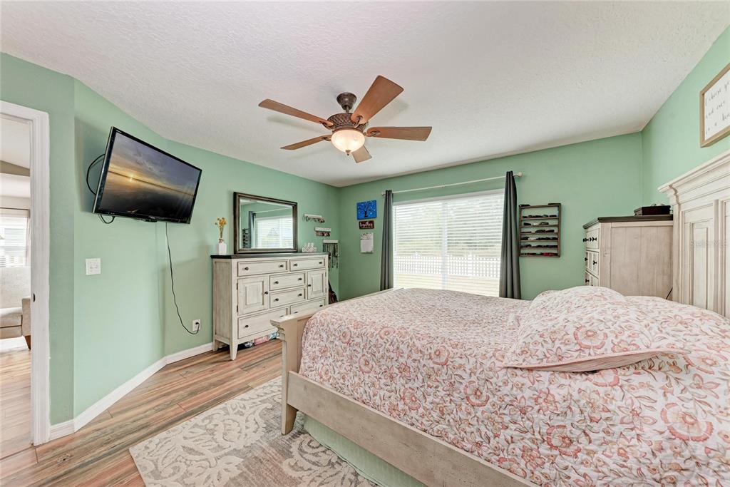 4608 Oliver Manor Drive Parrish, FL 34219 - Photo 17 of 45 a bedroom with a bed and a flat screen tv