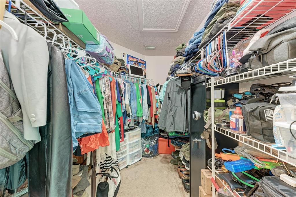 4608 Oliver Manor Drive Parrish, FL 34219 - Photo 18 of 45 a view of walk in closet with clothes