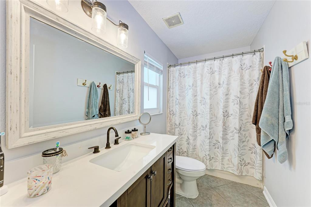 4608 Oliver Manor Drive Parrish, FL 34219 - Photo 19 of 45 a bathroom with a granite countertop sink toilet and shower