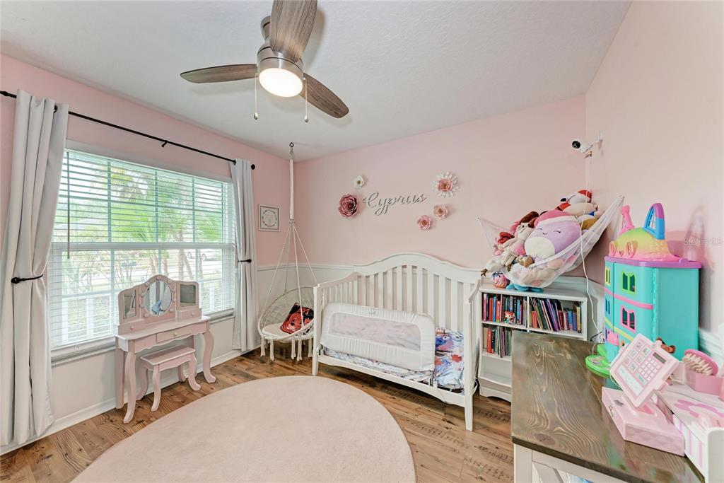 4608 Oliver Manor Drive Parrish, FL 34219 - Photo 20 of 45 a bedroom with furniture and a wooden floor