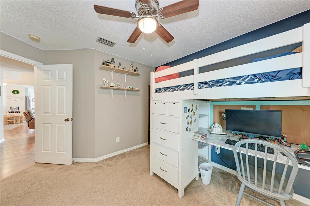4608 Oliver Manor Drive Parrish, FL 34219 - Photo 26 of 45 a living room with flat screen tv and a ceiling fan