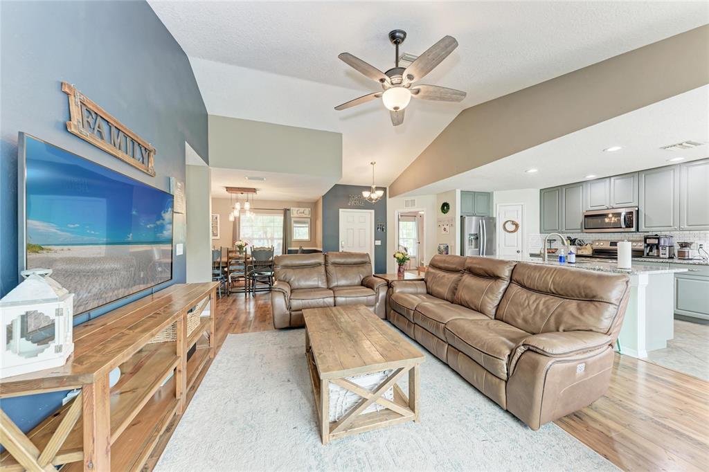 4608 Oliver Manor Drive Parrish, FL 34219 - Photo 7 of 45 a living room with furniture and a chandelier