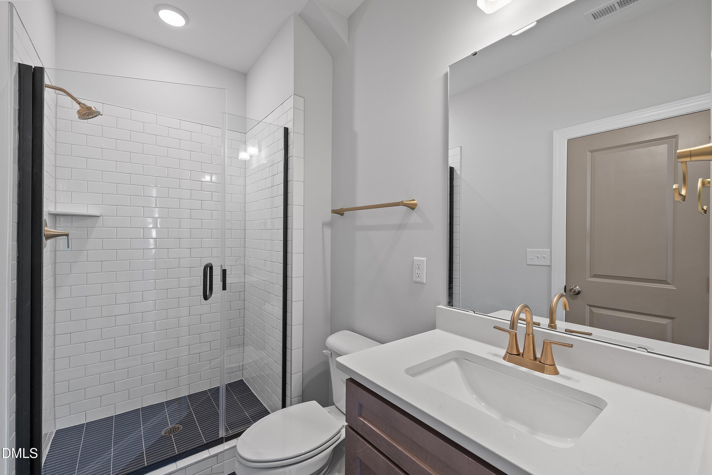 45 West Victoria Ridge Drive, Unit 32 Selma, NC 27576 - Photo 13 of 29 a bathroom with a sink toilet vanity and shower