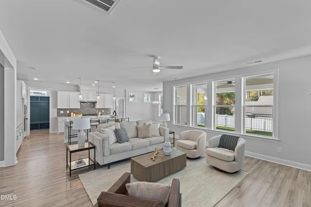 a living room with furniture and large windows