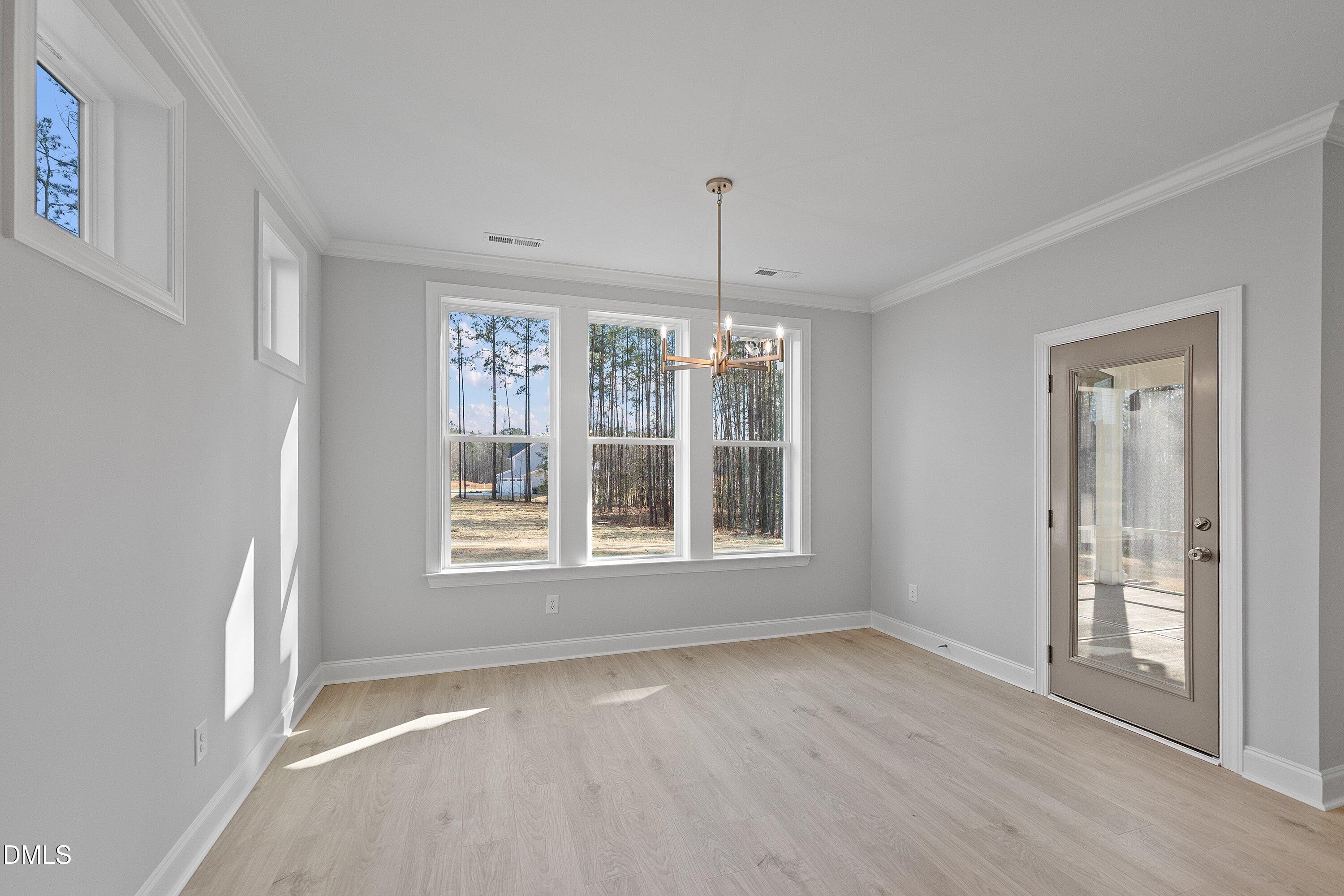 45 West Victoria Ridge Drive, Unit 32 Selma, NC 27576 - Photo 16 of 29 a view of an empty room with wooden floor and a window