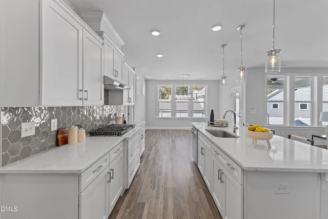 a kitchen with stainless steel appliances a sink stove and cabinets