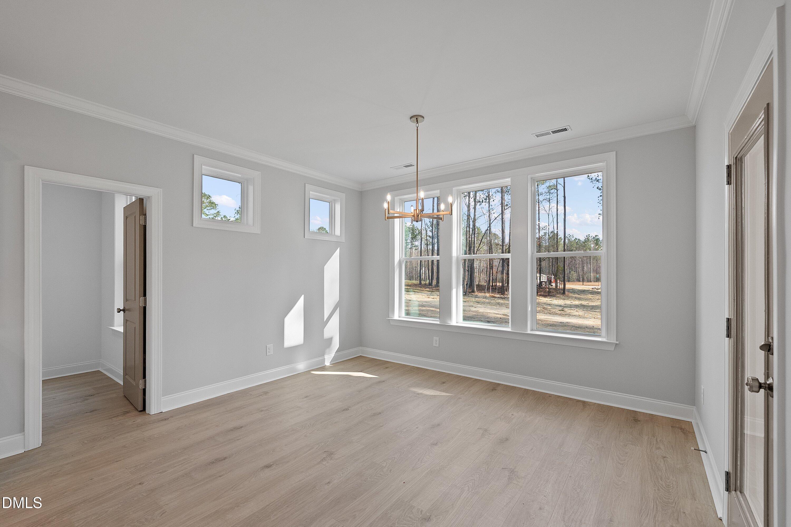 45 West Victoria Ridge Drive, Unit 32 Selma, NC 27576 - Photo 17 of 29 a view of an empty room with a window and wooden floor