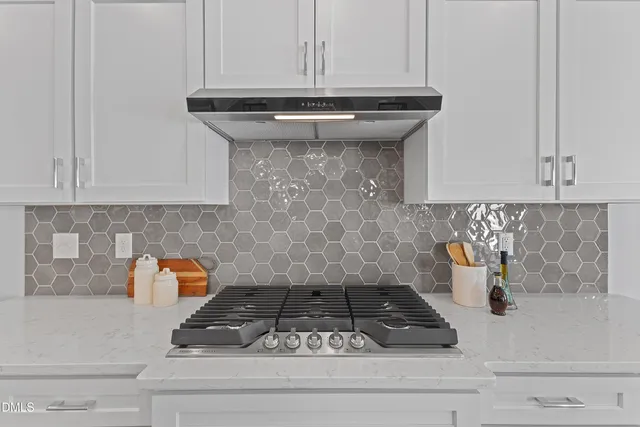 a kitchen with a stove and cabinets