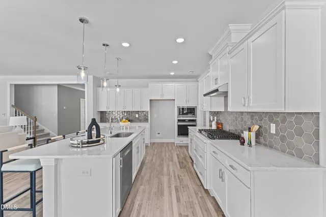 a kitchen with white cabinets sink and white appliances