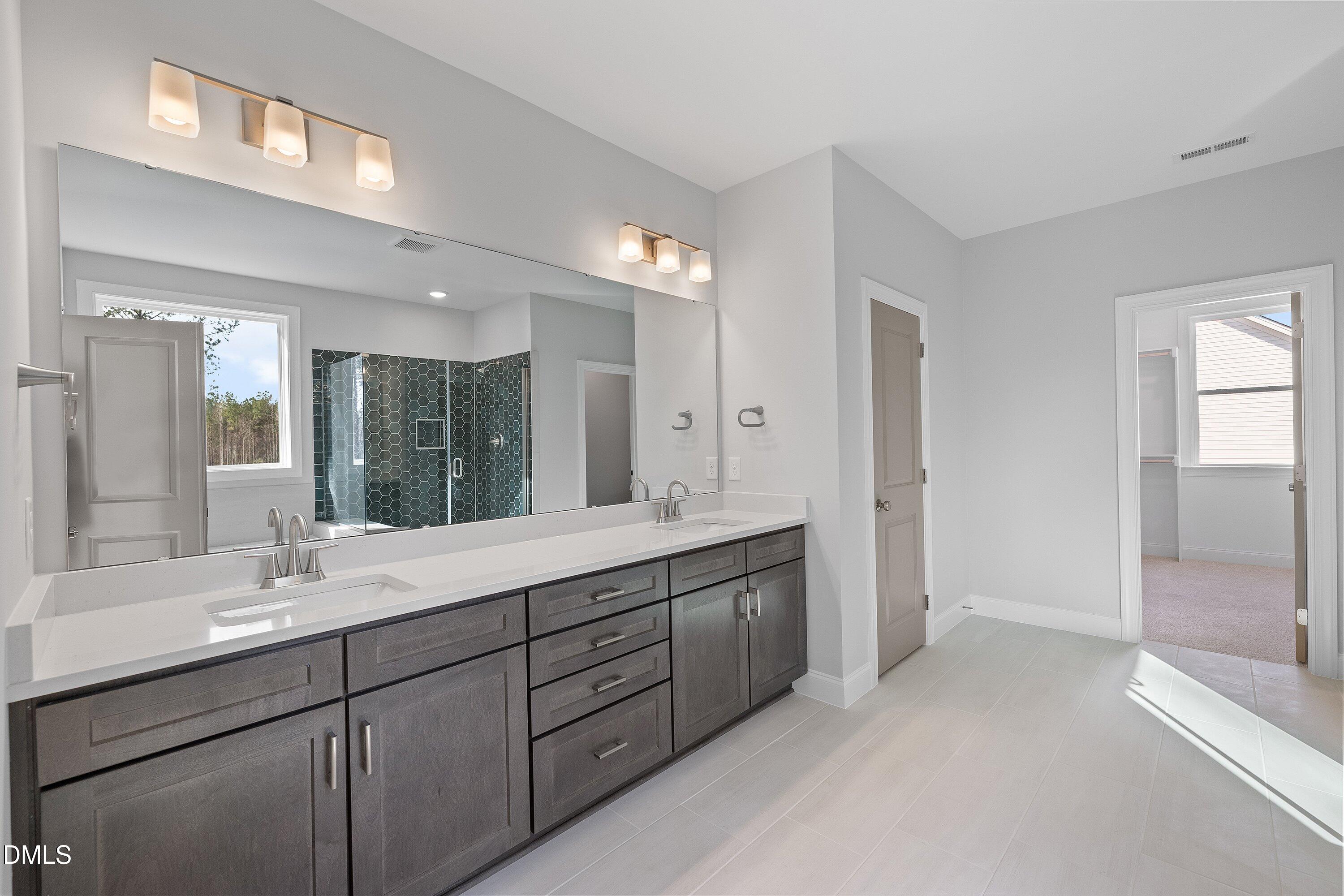 45 West Victoria Ridge Drive, Unit 32 Selma, NC 27576 - Photo 22 of 29 a bathroom with double vanity sinks and a mirror