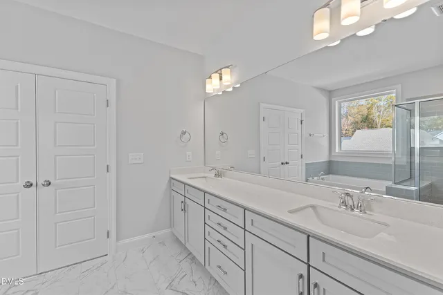 a bathroom with double sink and a mirror