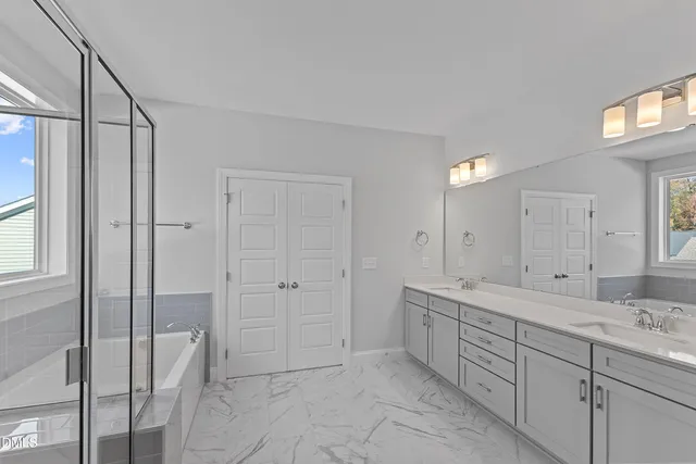 a spacious bathroom with a shower and a sink