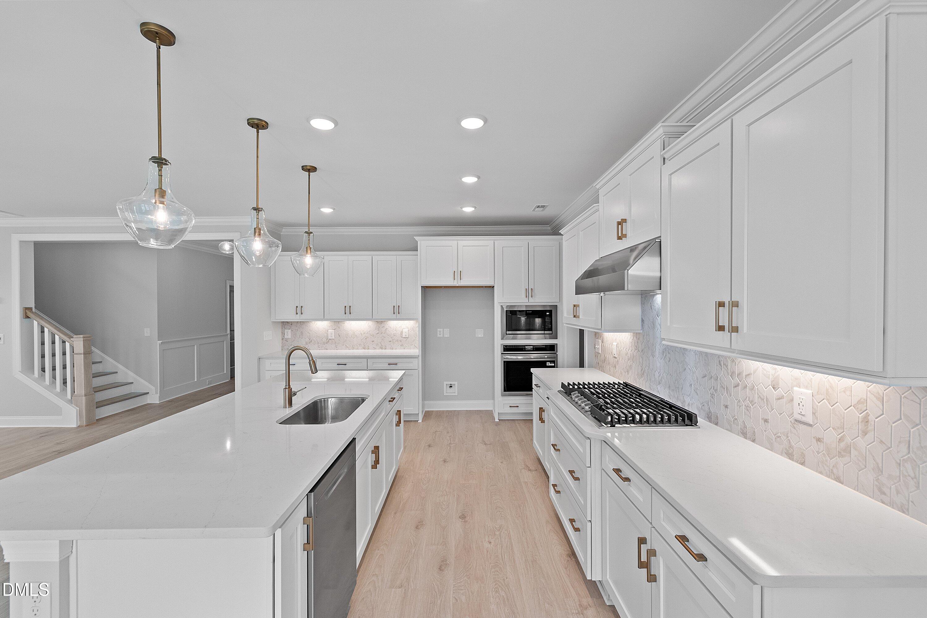 45 West Victoria Ridge Drive, Unit 32 Selma, NC 27576 - Photo 6 of 29 a kitchen with stainless steel appliances kitchen island granite countertop a sink and cabinets