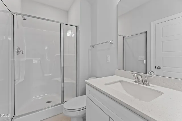 a bathroom with a granite countertop sink a toilet and shower