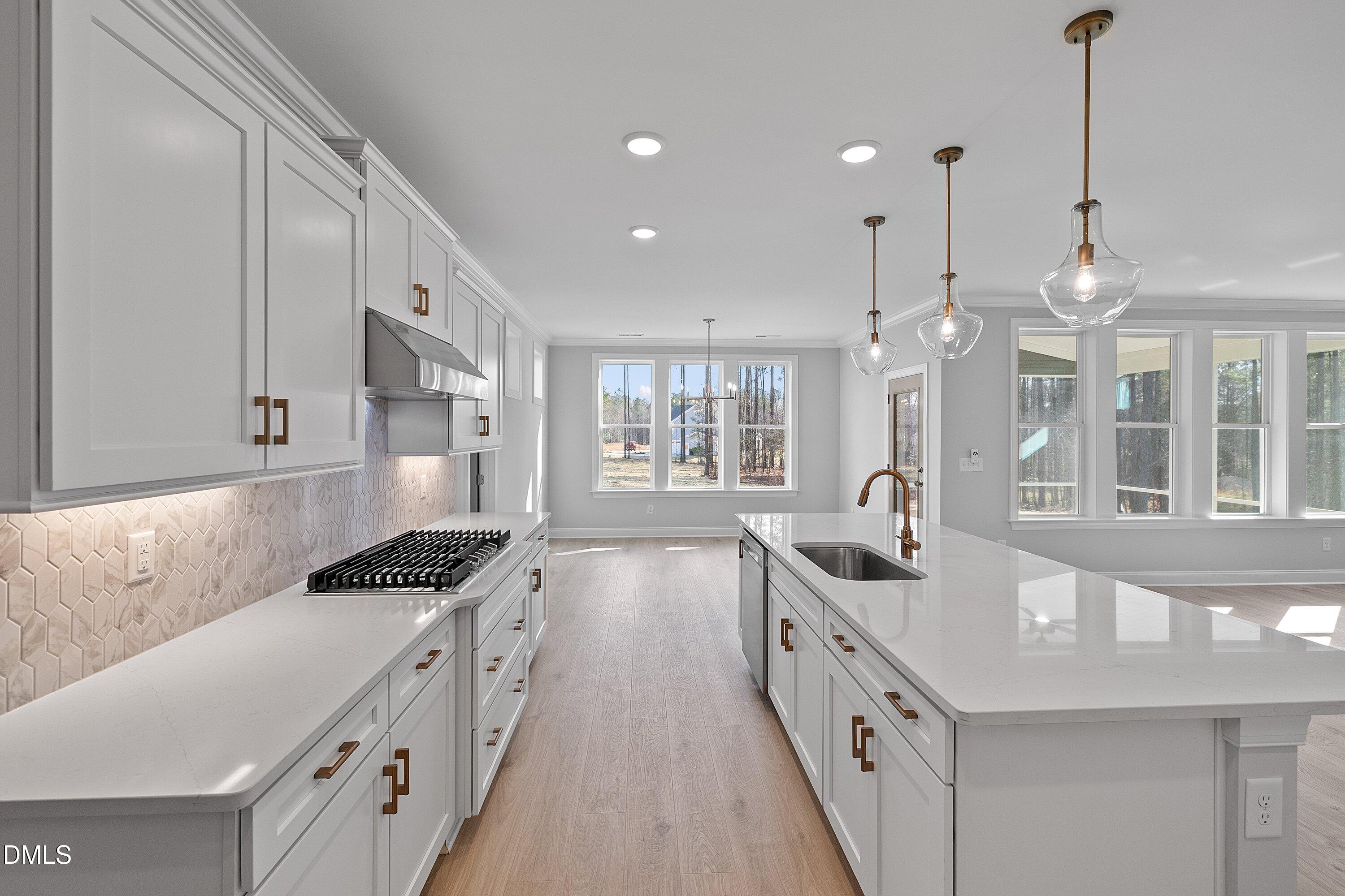 45 West Victoria Ridge Drive, Unit 32 Selma, NC 27576 - Photo 7 of 29 a kitchen with stainless steel appliances a sink a stove and a wooden floors