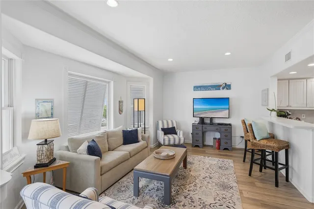 a living room with furniture a wooden floor and a fireplace