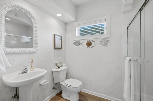 a bathroom with a sink mirror and toilet