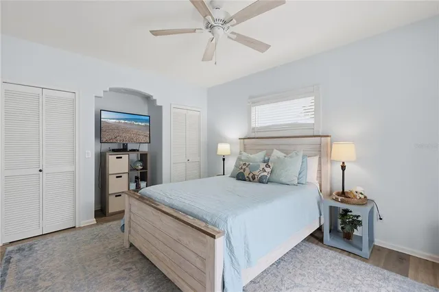 a bedroom with a large bed and a chandelier