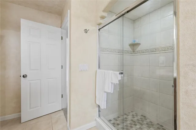 a bathroom with a glass shower door