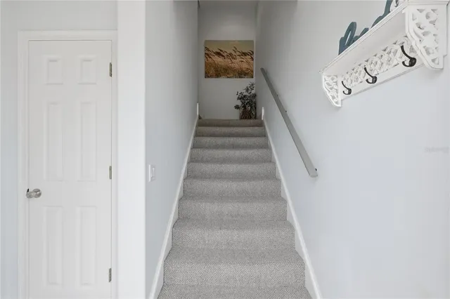 a view of staircase with white walls
