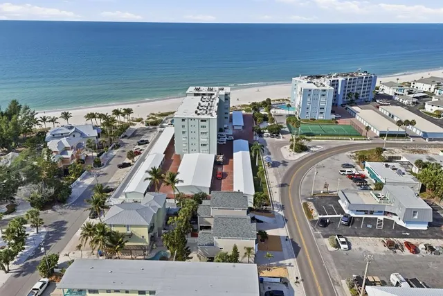 an aerial view of multiple houses with yard