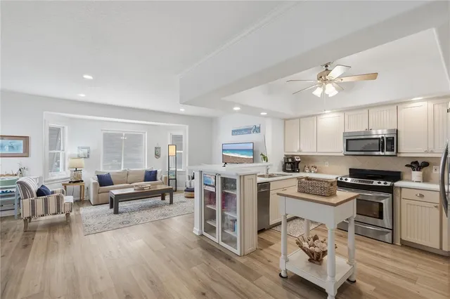 a living room with furniture and a kitchen view