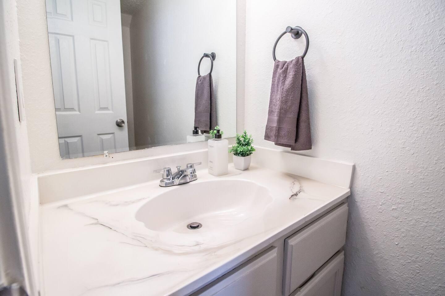 5806 6th Street, Unit B Lubbock, TX 79416 - Photo 39 of 45 a bathroom with a sink and a mirror