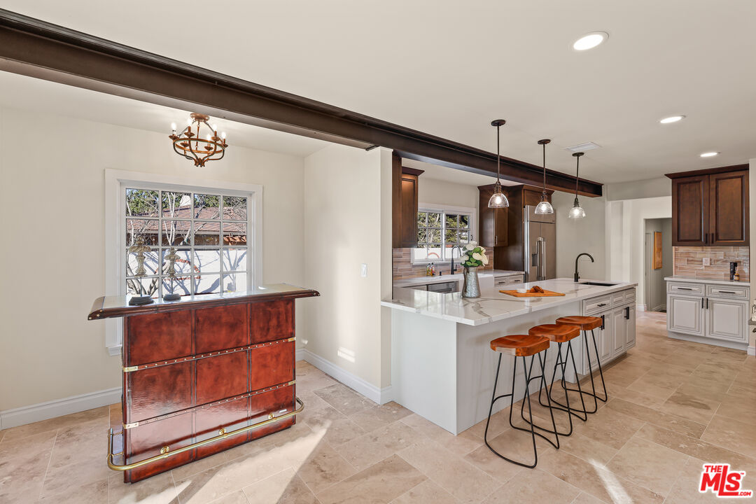 151 West Longden Avenue Arcadia, CA 91007 - Photo 11 of 46 a kitchen with stainless steel appliances kitchen island granite countertop a table chairs and a refrigerator