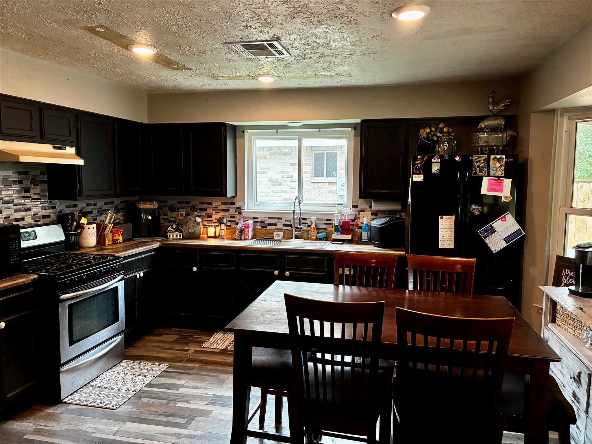 2 Sarita Road Angleton, TX 77515 - Photo 6 of 21 a kitchen with stainless steel appliances granite countertop a sink table and chairs