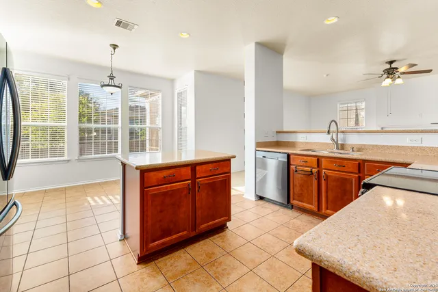 a kitchen with stainless steel appliances granite countertop a stove a sink and a microwave