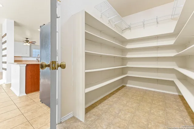 a view of walk in closet with empty racks