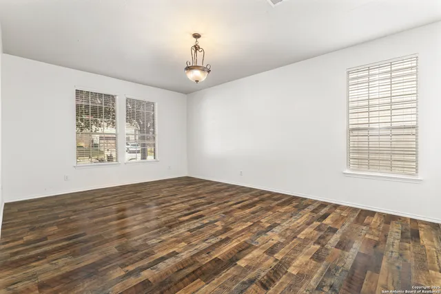 a view of an empty room with windows