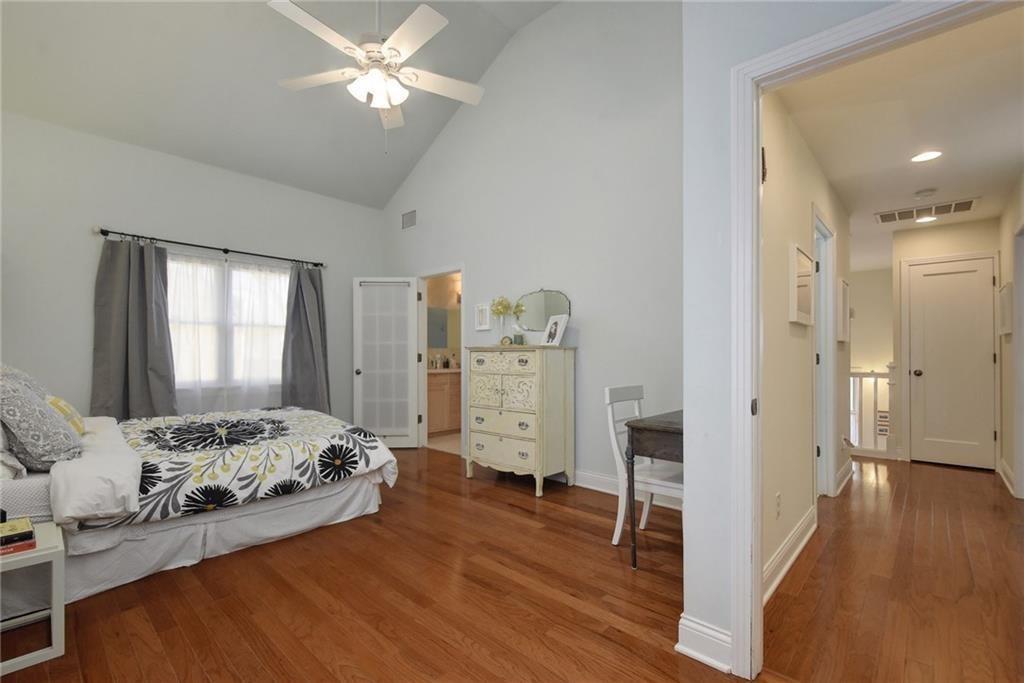 4412 Barrow Avenue, Unit A Austin, TX 78751 - Photo 15 of 28 Bedroom with wood finished floors, high vaulted ceiling, and a ceiling fan