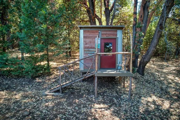 a red brick house with trees in front of it