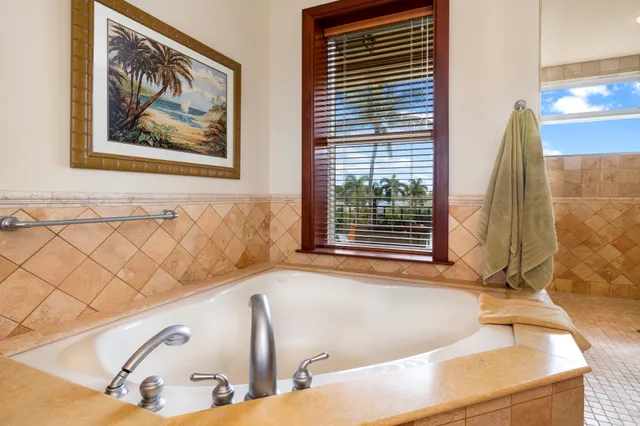 a bath tub sitting in a bathroom next to a window